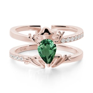 May include: Rose gold ring featuring a pear-shaped green gemstone and small white gemstones. The ring has an unusual design with antler-like details and the inscription "G14K". This ring is a piece of jewellery.