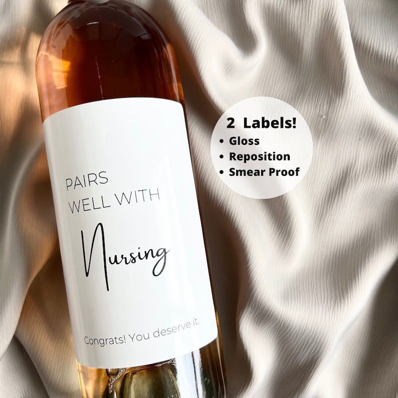 May include: A wine bottle with a white label that reads "PAIRS WELL WITH Nursing" in black script. The label also includes the text "Congrats! You deserve it." The image also shows a circle with the text "2 Labels!" and bullet points for "Gloss", "Reposition", and "Smear Proof".