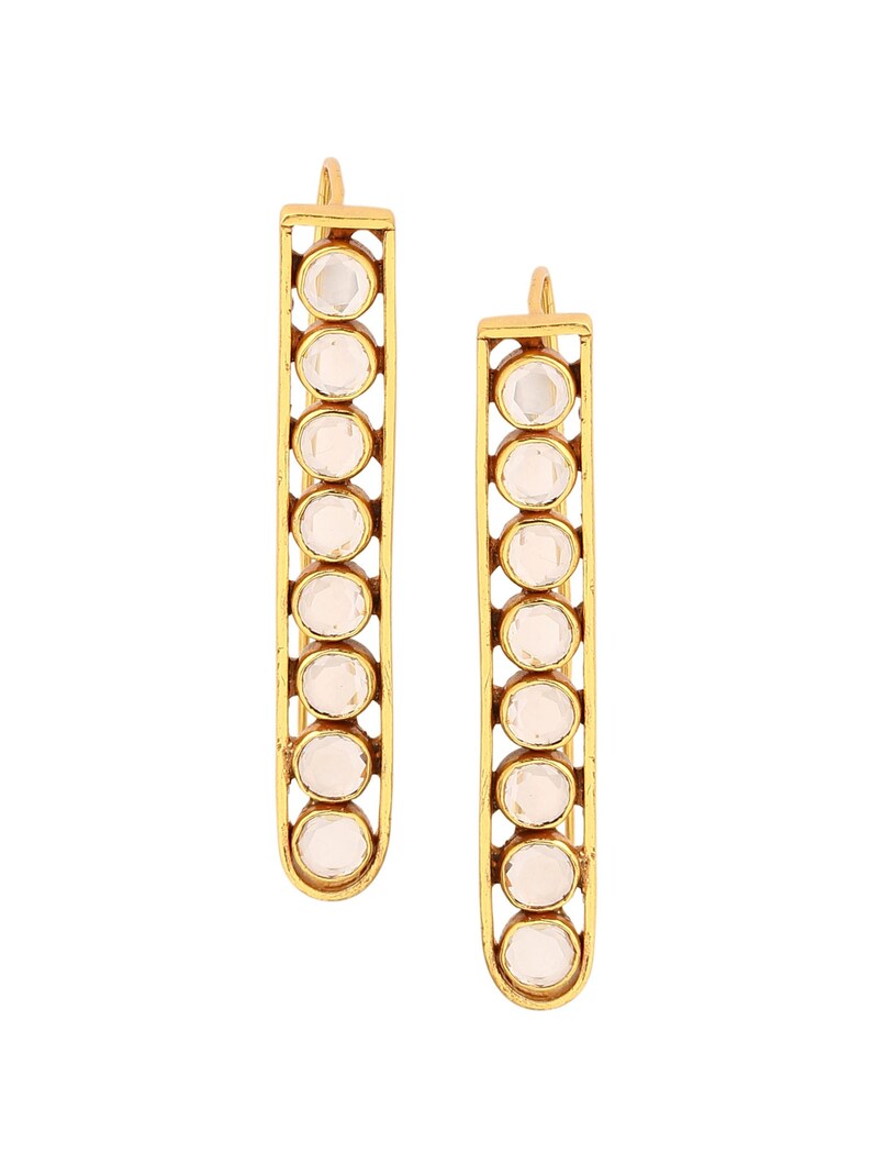 May include: A pair of gold earrings with clear stones. The earrings are long and rectangular in shape, with a row of stones down the center.