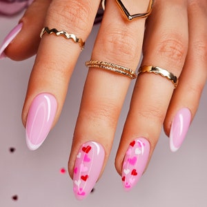 Crisp French with Pink and Red heart accent nails. Perfect for Valentines and so cute all year around. Hand made and reusable press on nails