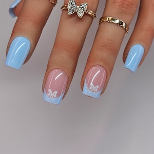 Baby blue french with bows. Summer trending, Reusable press on nails. Handmade by a qualified nail tech