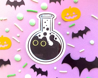 May include: A black and white illustration of a potion bottle with a black cat inside. The bottle is surrounded by bats, pumpkins, and other Halloween decorations.