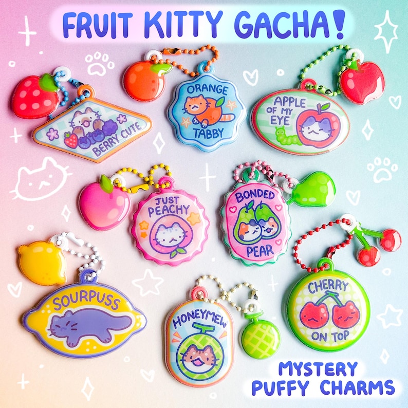 May include: A collection of colorful, puffy charms featuring fruit and cat designs. Each charm has a different fruit theme, such as strawberry, orange, apple, peach, pear, lemon, cherry, and honeydew. Text on the charms includes "Berry Cute," "Orange Tabby," and "Mystery Puffy Charms."