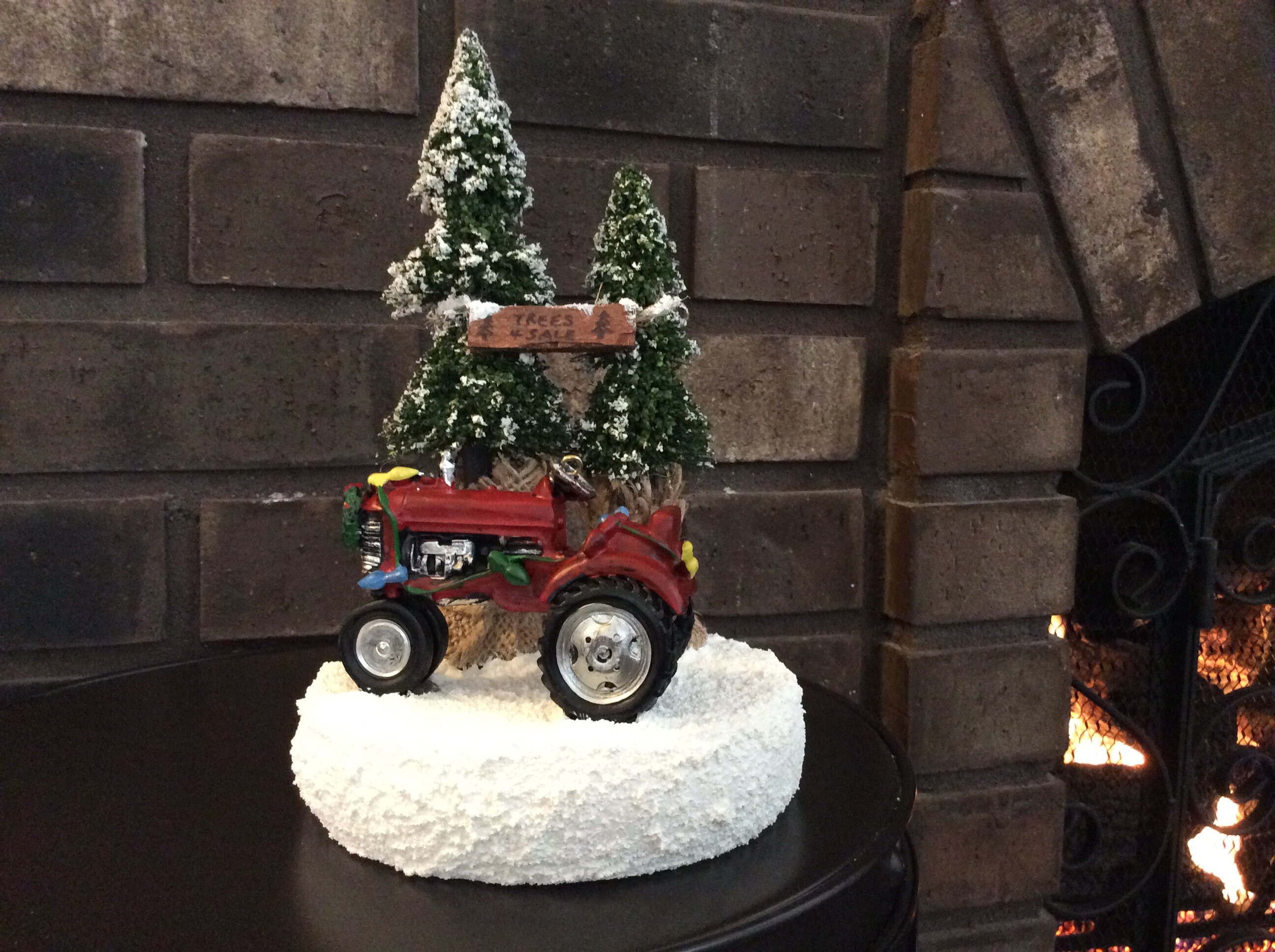 Red tractor decorated with holiday lights nestled within the Etsy