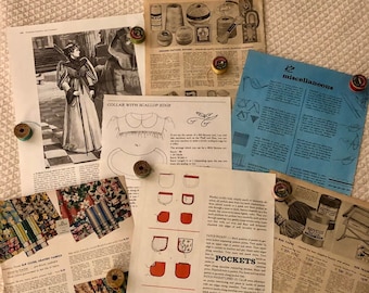 May include: A collection of vintage sewing patterns and fabric advertisements, held in place by colorful pin magnets. The patterns include instructions for collars, pockets, and other sewing projects. The color palette is primarily neutral with pops of red, blue, and green.