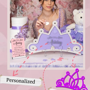 May include: A personalized tiara-shaped guest book with a purple and white design. The guest book has 50 wooden hearts that guests can sign and drop into the book. The text on the guest book reads "Miss XV A&ntilde;os Ashley 05/20/2023".