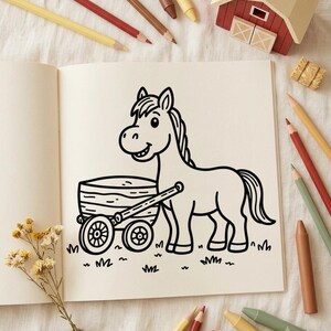 May include: A coloring book page featuring a black and white line drawing of a smiling horse pulling a wooden cart on a grassy patch. The page is surrounded by various colored pencils, a small wooden barn model, and a sprig of dried flowers.