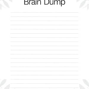 May include: A white paper sheet with the text Brain Dump printed in black at the top center. The page features horizontal lines for writing and is decorated with a light gray botanical leaf pattern along the top and bottom edges of the page.