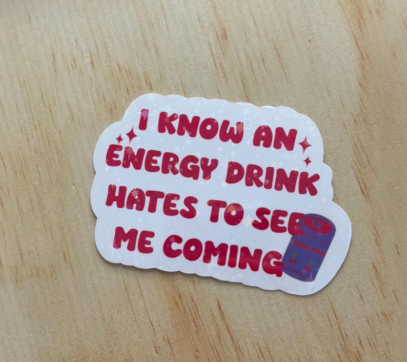 May include: White sticker with pink text that reads "I know an energy drink hates to see me coming". A purple and white energy drink can is in the bottom right corner of the sticker.