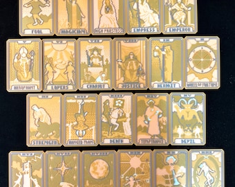 May include: A collection of twenty-two tarot cards, each featuring a unique illustration and title. The cards have a gold and beige color scheme with pixelated artwork. The titles include "Fool," "Magician," and "High Priestess."