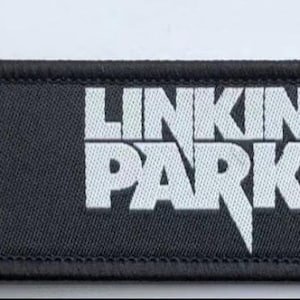 May include: Black keychain with a white Linkin Park logo and a white stylized 'A' in a circle.
