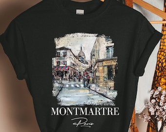 Puede incluir: Camiseta negra con una ilustración de acuarela de una escena callejera en Montmartre, París. El texto "Montmartre Paris" está impreso debajo de la imagen.