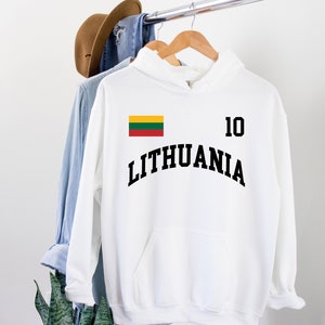 May include: A white hooded sweatshirt featuring the word LITHUANIA in black arched lettering, the number 10 in black, and a small rectangular flag of Lithuania with yellow, green, and red horizontal stripes printed on the upper chest area.