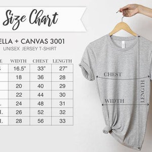 May include: A light gray unisex jersey t-shirt hanging on a wooden hanger. The image includes a size chart with measurements in inches for width, chest, and length. The text on the chart reads "BELLA + CANVAS 3001".