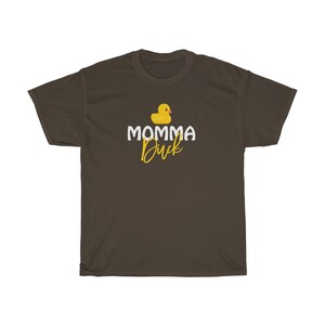 May include: A brown t-shirt featuring a yellow rubber duck and the text "MOMMA Duck" in white.