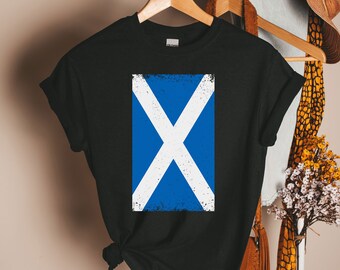May include: A black t-shirt with a distressed white and blue Scottish flag design.