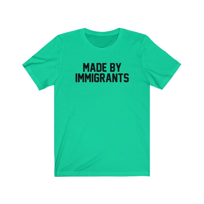 May include: A bright green t-shirt with the text "MADE BY IMMIGRANTS" printed in black.