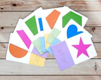 May include: A set of colorful flashcards featuring different shapes, including a circle, square, rectangle, triangle, heart, star, and arrow. Each card has the name of the shape written on it.