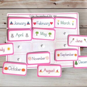 May include: Pink cards with the months of the year printed on them. Each card has a small illustration representing the month. The cards are scattered on a wooden surface. "Order the months of the year" is printed at the top of the page.