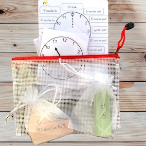 May include: A red mesh bag filled with white paper clock faces, a wooden clock face with the text "20 minutes to 11", and a green card with the text "O'clock".
