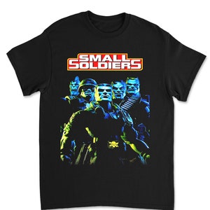 May include: Black t-shirt with a graphic of the characters from the movie "Small Soldiers". The characters are in a green and blue color scheme and the title of the movie is in red and yellow.