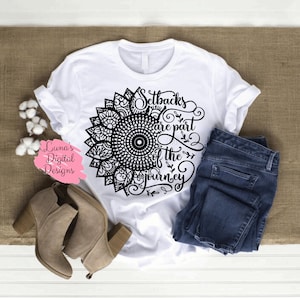 May include: White t-shirt with a black mandala design and the text "Setbacks are part of the journey".