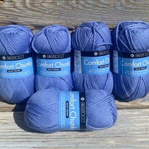 May include: Five balls of blue yarn labeled "Berroco Comfort Chunky" with the text "Bulky Weight 50% Super Fine Nylon Nylon Super Fine 30% Super Fine Acrylic Acrylique Super Fine 10% Super Fine Acrylic Acrylique Super Fine"