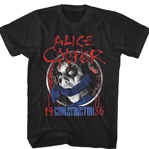 May include: Black t-shirt with a red and white graphic of Alice Cooper's face with a blue and white scarf over his mouth. The graphic is surrounded by a red circle with the text "Alice Cooper" in red and white. The text "1986" and "Constrictor" are below the graphic in red and white.