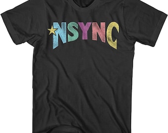 May include: Black t-shirt featuring the word "NSYNC" in colorful, distressed lettering. A gold star is next to the letter "N". The shirt has a classic crew neck and short sleeves.