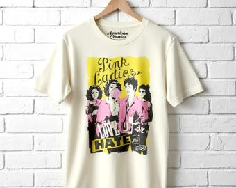 Camiseta rosa para mujer de Grease con la frase "Love or Hate Us" (Tema retro de la película)