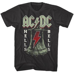 May include: Black t-shirt featuring the band AC/DC's logo and the words "HELLS BELLS". The design includes a bell with a red lightning bolt. The shirt is a classic crew neck style.