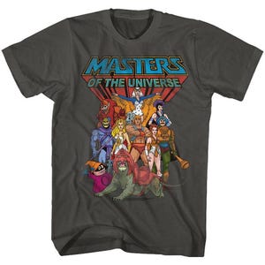 May include: Dark gray t-shirt featuring the text "MASTERS OF THE UNIVERSE" above a group of cartoon characters. The graphic includes characters in various colors, including red, blue, and yellow.