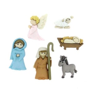 May include: A set of six felt Christmas nativity buttons featuring a blue robed Mary, a brown robed Joseph, a pink angel, a white lamb, a brown donkey, and a brown manger with a baby Jesus.