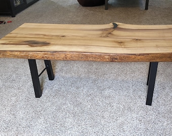 Live Edge Solid Wood Coffee table with metal base.