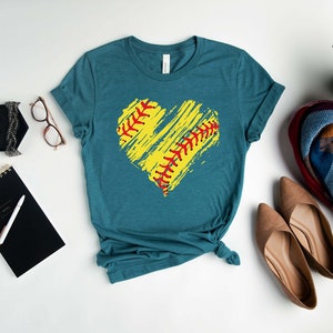 May include: Teal blue t-shirt with a yellow and red softball design in the shape of a heart.