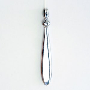 May include: A silver metal pull chain with a rounded, teardrop-shaped end.