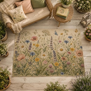 May include: A rectangular area rug featuring a detailed botanical print of wildflowers, including daisies, poppies, and cornflowers in shades of pink, yellow, blue, and white, accented with small butterflies on a light cream-colored background.