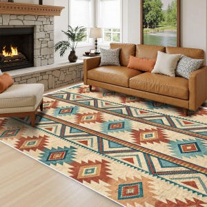 May include: A rectangular area rug with a Southwestern geometric pattern in shades of beige, red, and turquoise. The rug is placed in a living room with a leather sofa, fireplace, and natural light.