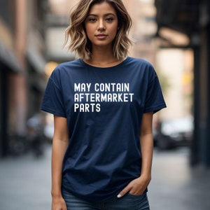 May include: A navy blue t-shirt with white text that reads "MAY CONTAIN AFTERMARKET PARTS".