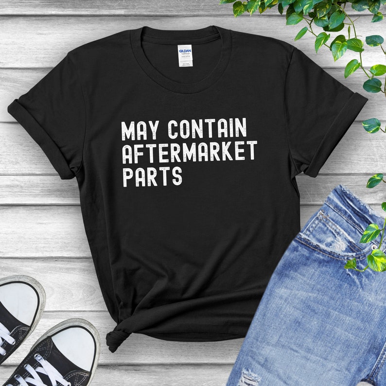 May include: Black t-shirt with white text that reads "May Contain Aftermarket Parts".