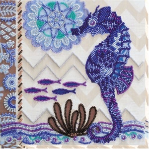 May include: A beaded seahorse with a blue, purple, and white color scheme. The seahorse is surrounded by a beaded floral design, a school of fish, and a brown seaweed plant.