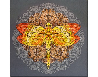May include: A yellow and orange dragonfly with intricate details is depicted in a diamond-shaped mandala design. The dragonfly is made of small beads and is set against a dark gray background.