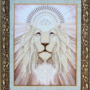 May include: A white beaded lion with a crown of beads and a mandala design in the centre of its chest. The lion is framed in a gold ornate frame.