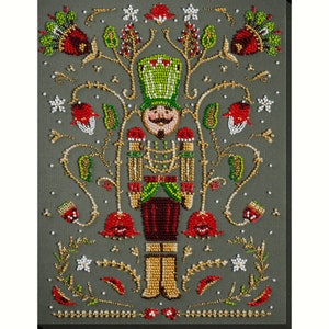 May include: A beaded nutcracker figurine with a green hat and red and gold accents. The nutcracker is surrounded by a beaded floral design with red flowers and green leaves.