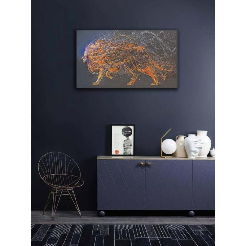 May include: Abstract art print of a lion with orange and yellow lines and dots on a dark gray background.