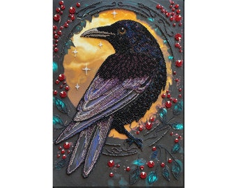 May include: A beaded artwork depicting a black raven with iridescent feathers, perched within a circular frame of red berries and green leaves against a golden background with stars.
