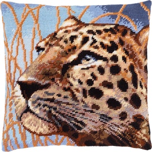 May include: Square decorative pillow featuring a detailed cross-stitch design of a leopard's face. The pillow has a light blue background with brown and tan accents, and a brown and tan leopard face with black spots.