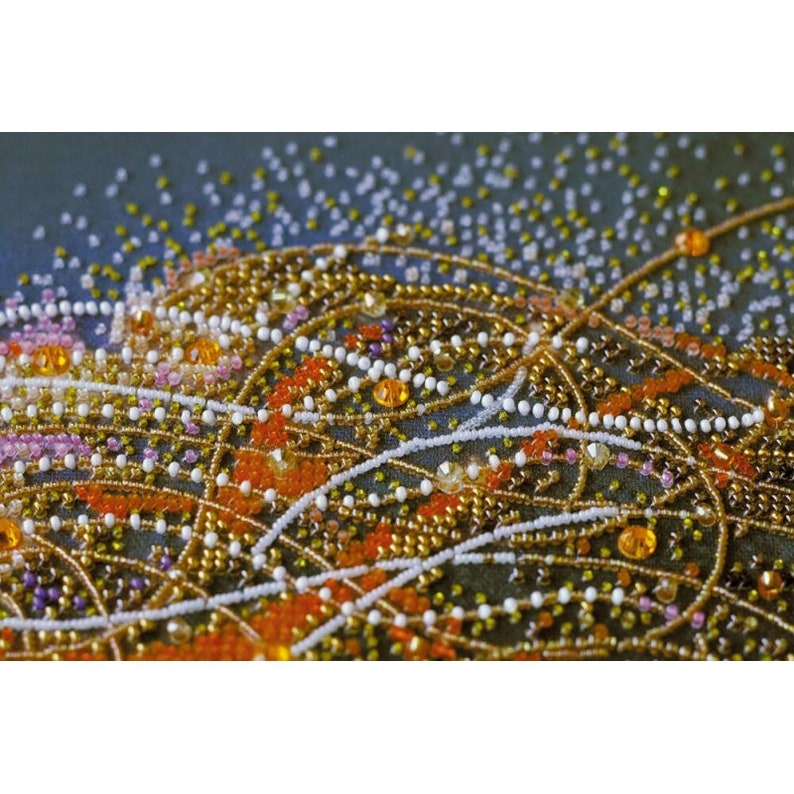 May include: Close-up of a beaded design with a variety of colors, including orange, gold, white, and pink. The beads are arranged in a swirling pattern, creating a textured and intricate design.