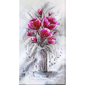 May include: A bouquet of pink flowers in a clear glass vase. The flowers are arranged in a loose, natural style. The background is a soft, gray color.