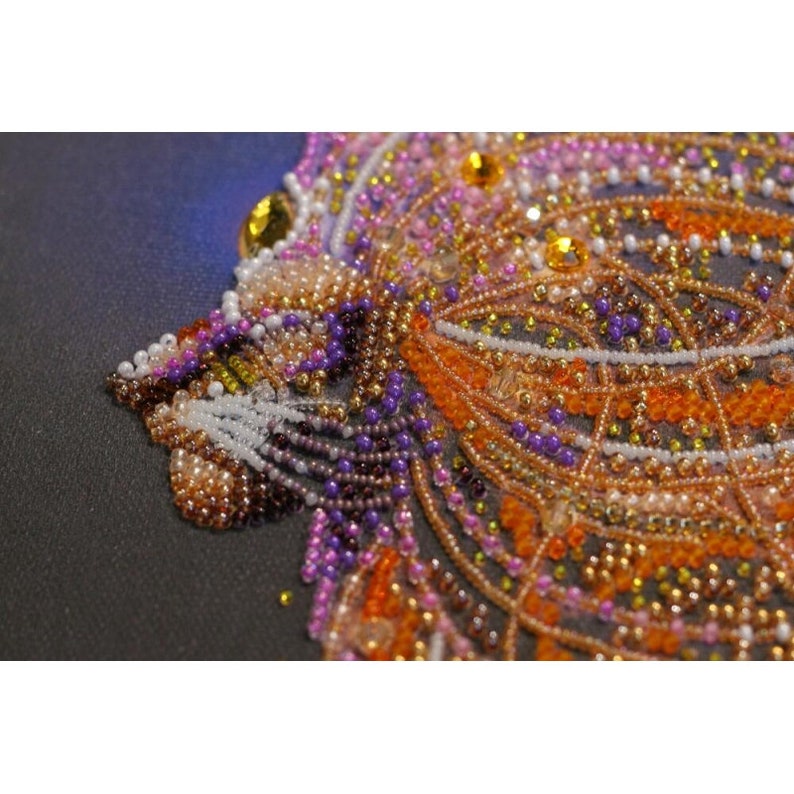 May include: Close-up of a beaded tiger face with orange, purple, and gold beads. The beads are arranged in a detailed pattern, creating a realistic depiction of the tiger's face.